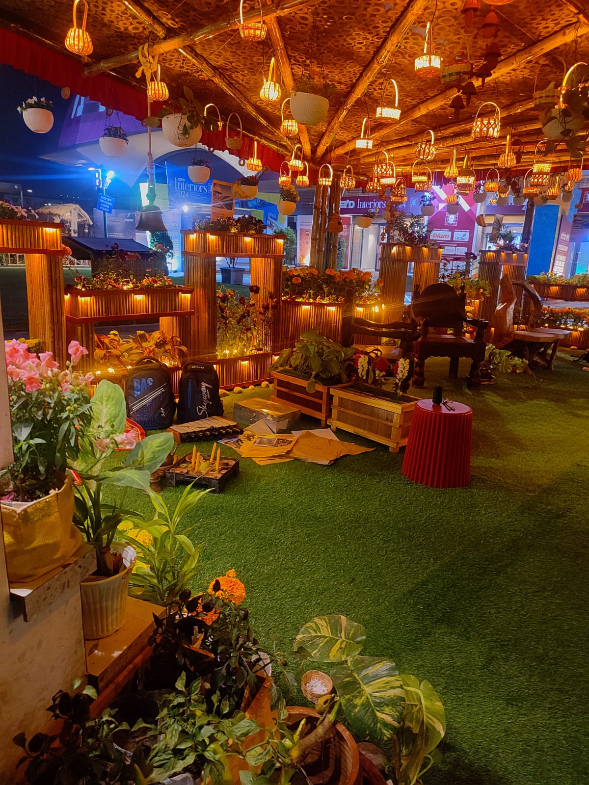The completed interior — hanging lanterns, plants everywhere