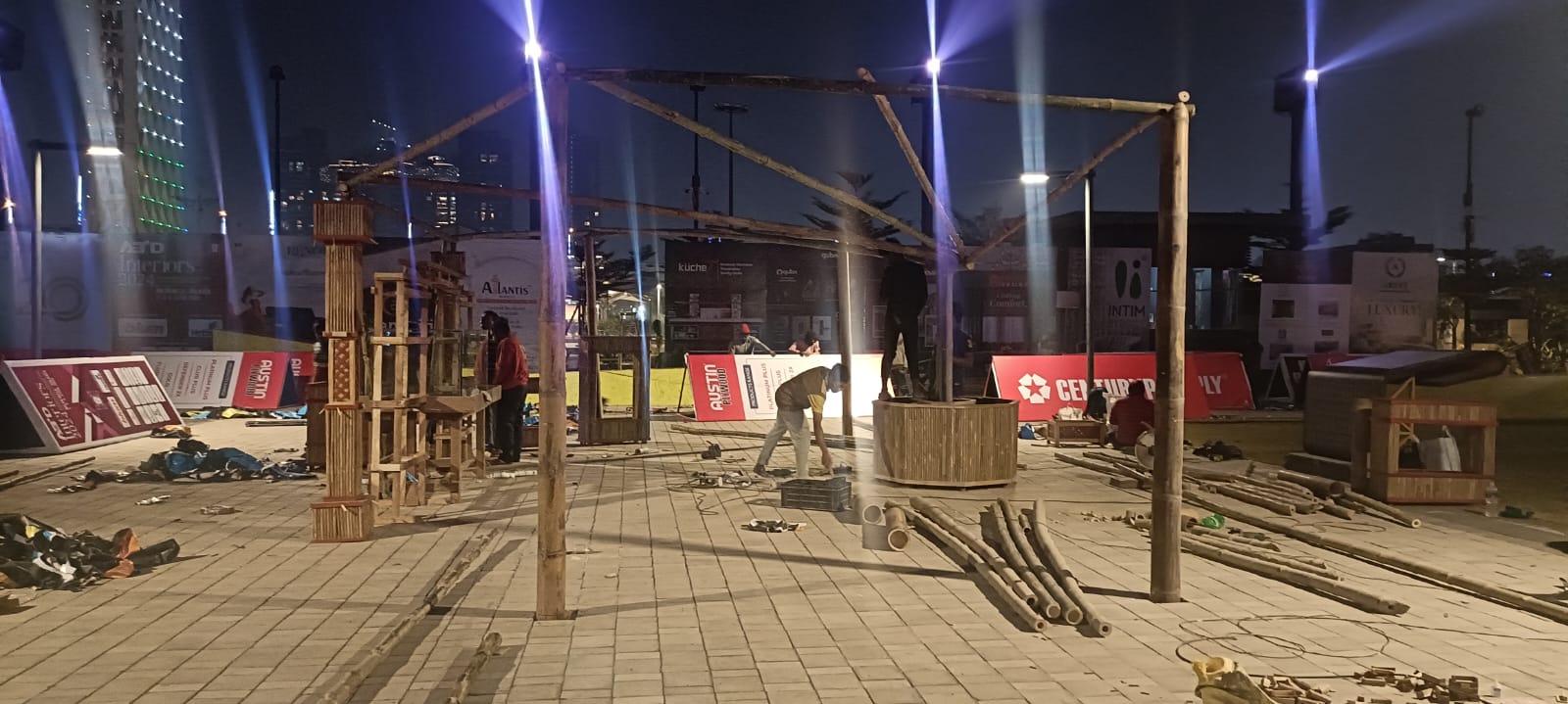 Night one — bare bamboo skeleton, scattered poles on empty ground